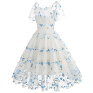 Close-up of elegant floral embroidery on white mesh tulle of the 50s vintage party dress