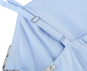 Detail of light blue dress with adjustable metallic buckle and floral lace embroidery