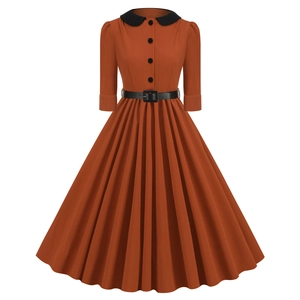 Detailed view of the retro rust orange dress with black peter pan collar and waist belt