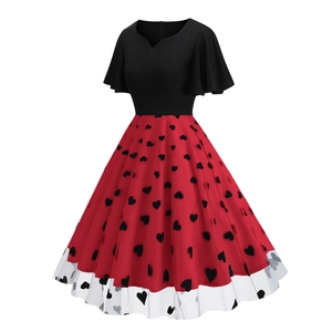 Detailed view of flutter sleeves and heart-patterned mesh hem on a vintage dress
