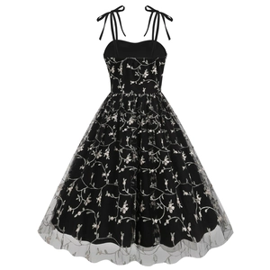 Close-up of floral embroidery on black mesh dress with adjustable ribbon straps