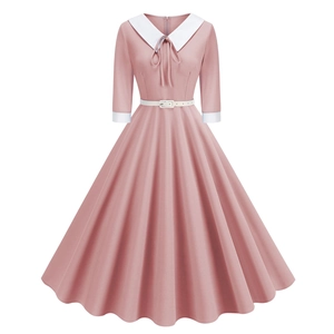 Close-up of pink vintage A-line dress featuring Peter Pan collar and white bow tie