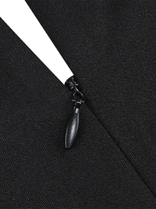 Close-up of invisible black zipper and textured woven fabric on cocktail dress back