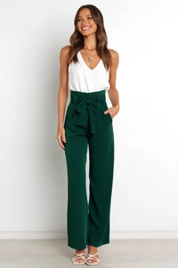 Detail view of high-waist wide-leg trousers with elegant bow belt and sleeveless V-neck top