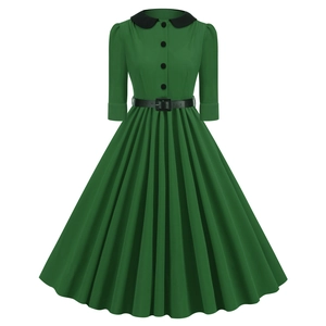 Detail of vintage green dress featuring a black Peter Pan collar and waist belt accents