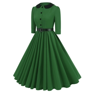Detail of vintage dark green dress showing black Peter Pan collar and waist belt features