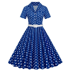 Detail of royal blue polka dot vintage dress with short sleeves and white belt