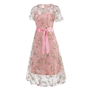 Detailed embroidery of pink flowers and green leaves on sheer mesh dress fabric