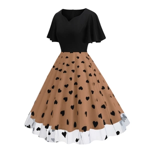 Detail of 1950s retro cocktail dress featuring heart pattern mesh and flutter sleeves