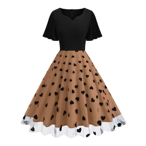 Detail of 50s vintage dress featuring heart flocked pattern and mesh hem stitching