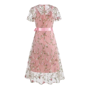 Detail of pink floral embroidery on sheer mesh dress with elegant satin ribbon tie