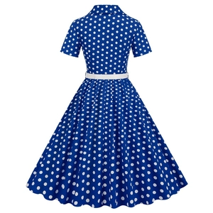 Back view of a vintage royal blue polka dot dress with short sleeves and wide flare skirt
