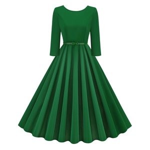 Detail view of green vintage dress with pleated skirt and slim waist belt accessory