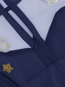 Detail view of the gold star sequins and invisible zipper on the blue tulle dress