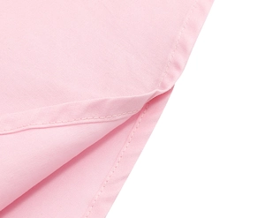 Gros plan détaillé de la fente latérale et des coutures plates sur le tissu rose de robe