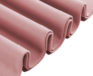 Detailed macro view of pleated fabric with double-row stitching on pink dress hem