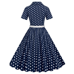 Detail of vintage navy blue polka dot dress with lapel collar and slim white waist belt