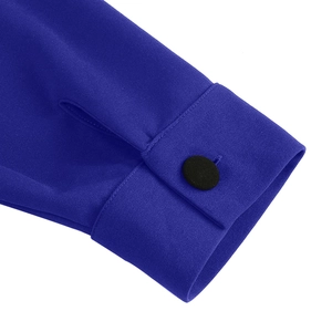 Close-up of royal blue dress sleeve featuring fine fabric texture and a black button detail