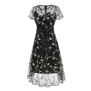Close-up of black mesh dress with detailed pink floral embroidery and satin bow belt