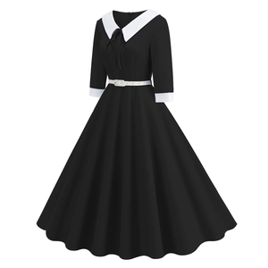 Detail of elegant black A-line dress with white contrast collar and waist belt tie