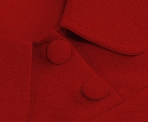 Macro detail of elegant red vintage dress showing lapel collar and matching fabric buttons