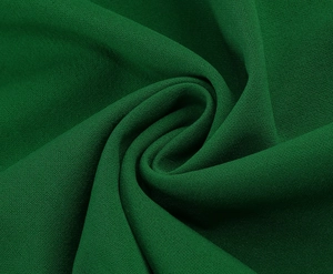 Detail of forest green chiffon fabric showing textured weave and elegant drape