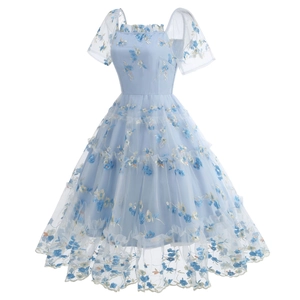 Macro shot of light blue mesh dress featuring intricate floral embroidery and tiered layering