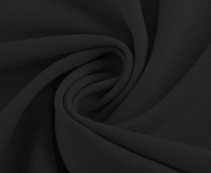 Macro shot of elegant black chiffon fabric texture with soft pleated spiral draping