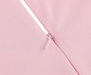 Detail of invisible zipper closure on pink embroidered 50s cocktail dress fabric