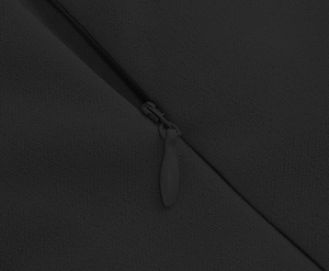 Detail of invisible zipper on black textured dress fabric with fine grain surface finish