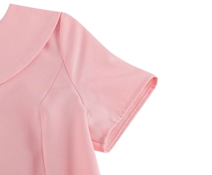 Close-up of pink short sleeve dress showing fine fabric texture and neat stitching details