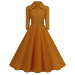 Detail of yellow vintage A-line dress featuring a classic Peter Pan collar and button accents