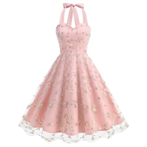 Detail of pink mesh overlay featuring exquisite floral embroidery on a vintage party dress