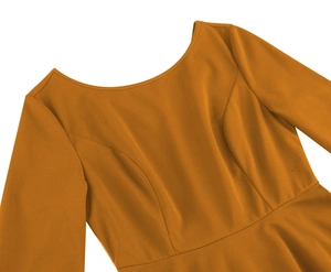 Detail view of mustard yellow dress featuring a round neck and princess seams