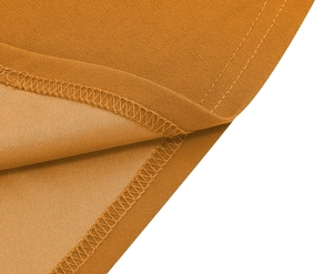 Macro view of detailed edge stitching and textured chiffon fabric in burnt orange