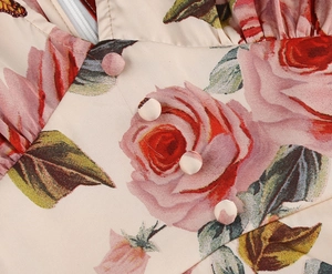 Detail of rose floral print on vintage V-neck dress with fabric-covered buttons