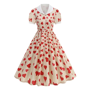 Detail of vintage heart print dress featuring a white Peter Pan collar and puff sleeves