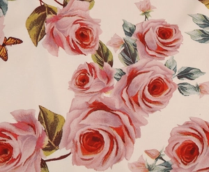 Detailed close-up of rose flower print and butterfly pattern on the beige fabric texture
