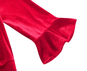 Detail of red velvet short sleeve dress showing elegant ruffle cuff and glossy fabric texture