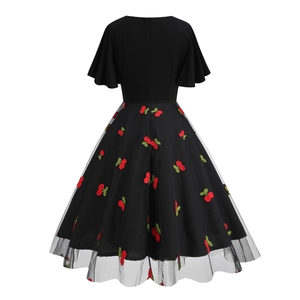 Close-up of red cherry embroidery on black mesh skirt with retro A-line vintage hem
