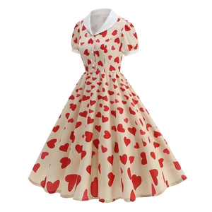 Close-up of retro cream dress with red heart prints and white lapel collar detail