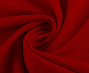 Detail view of premium dark red chiffon fabric with professional draped texture and spiral fold