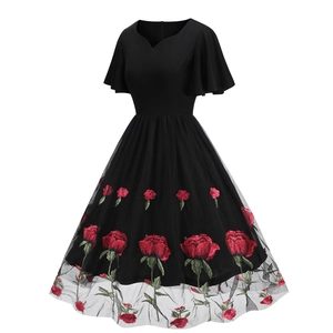 Close-up of elegant red rose floral embroidery on black mesh tulle 50s vintage dress