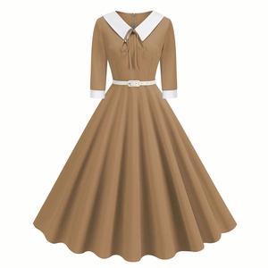 Close-up of contrast Peter Pan collar with delicate bow and white sleeve cuffs detail