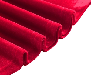 Macro shot of premium red velvet fabric showing smooth texture and detailed stitching