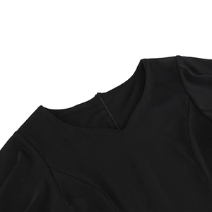 Detailed view of black V-neckline with high-quality stitching and hidden back zipper