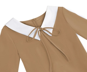 Detailed view of deep khaki brown dress featuring a white Peter Pan collar and bow tie