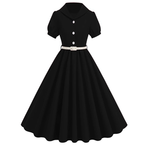 Detail view of vintage black dress featuring white contrast buttons and high waist belt
