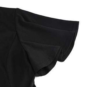 Detailed macro shot of the black dress layered ruffle sleeve and pleated fabric texture