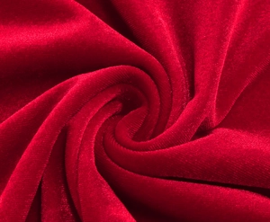 Macro shot of premium dark red velvet fabric with soft texture and elegant sheen